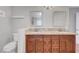 Bathroom with granite countertop, wood cabinets, and double sinks at 3079 Evening Mist Ave, Henderson, NV 89052