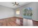 Bright bedroom with hardwood floors, ceiling fan, and sliding glass door to the backyard pool at 3079 Evening Mist Ave, Henderson, NV 89052