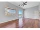 Bright bedroom with hardwood floors, ceiling fan, and sliding door to patio at 3079 Evening Mist Ave, Henderson, NV 89052