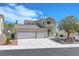 Stunning two-story house with a three-car garage and beautifully landscaped front yard with vibrant desert plants at 3079 Evening Mist Ave, Henderson, NV 89052