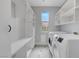 Bright laundry room with modern washer and dryer, ample storage, and lots of natural light at 3079 Evening Mist Ave, Henderson, NV 89052