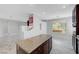 Spacious living area with marble flooring, kitchen island, and modern gray paint scheme at 3079 Evening Mist Ave, Henderson, NV 89052