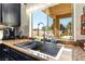 Kitchen with stainless steel sink and faucet and backyard view at 3309 Green Ice Ave, North Las Vegas, NV 89081