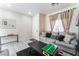 Cozy living room with a sofa, stylish decor, tiled floors, and lots of natural light at 3309 Green Ice Ave, North Las Vegas, NV 89081