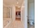 Bright bathroom featuring a bathtub, glass shower, walk-in closet, and toilet area at 353 E Bonneville Ave # 313, Las Vegas, NV 89101
