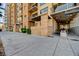 Modern condo building entrance with stone accents, covered walkway, and well-maintained landscaping offers an inviting welcome at 353 E Bonneville Ave # 313, Las Vegas, NV 89101