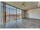Condo living room features large windows, hardwood floors, and modern lighting for stylish and comfortable urban living at 353 E Bonneville Ave # 313, Las Vegas, NV 89101
