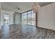 Spacious condo living room boasts hardwood floors, oversized windows, and modern chandelier providing a stylish and bright space at 353 E Bonneville Ave # 313, Las Vegas, NV 89101