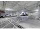 Indoor parking garage featuring parking spaces, support beams, and overhead lighting at 353 E Bonneville Ave # 313, Las Vegas, NV 89101