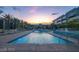 Large swimming pool reflecting the colorful sunset near modern condos at 353 E Bonneville Ave # 313, Las Vegas, NV 89101