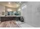 Bathroom featuring double sink vanity, modern lighting, glass shower and decorative tiles at 365 Sapphire Rock Ave, Las Vegas, NV 89183