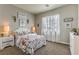 Bedroom featuring a floral pattern bedset, bedside tables, stylish lighting and a large window at 365 Sapphire Rock Ave, Las Vegas, NV 89183