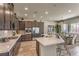 Modern kitchen with stainless steel appliances, quartz countertops, and an open layout to the dining area at 365 Sapphire Rock Ave, Las Vegas, NV 89183