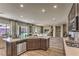 Open concept kitchen with stainless appliances, large island and a view into the breakfast nook and living room at 365 Sapphire Rock Ave, Las Vegas, NV 89183