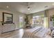 Bright main bedroom showcasing wood floors, a ceiling fan, and views into the backyard at 365 Sapphire Rock Ave, Las Vegas, NV 89183