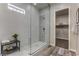 Glass enclosed shower with white decorative tiles and a view into the walk-in closet at 365 Sapphire Rock Ave, Las Vegas, NV 89183
