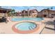Community pool and jacuzzi surrounded by lounge chairs and beautiful landscaping at 4083 Nook Way # A, Las Vegas, NV 89103