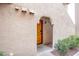 Inviting courtyard entry featuring a wooden front door, rock landscaping, and a covered entrance way at 4083 Nook Way # A, Las Vegas, NV 89103