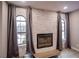 Contemporary living space highlighting a stone accent wall with fireplace, hardwood flooring, and sheer window treatments at 4083 Nook Way # A, Las Vegas, NV 89103