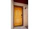 Close-up of the charming front door with elegant hardware and an adjacent wall-mounted light fixture at 4083 Nook Way # A, Las Vegas, NV 89103