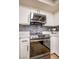 Close up of stainless steel appliances and gray backsplash at 4083 Nook Way # A, Las Vegas, NV 89103