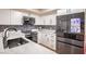 Modern kitchen features white cabinetry, sleek appliances, and a stylish backsplash at 4083 Nook Way # A, Las Vegas, NV 89103