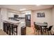 Stylish kitchen featuring white cabinetry, a marble countertop bar with seating, and an adjoining dining area at 4083 Nook Way # A, Las Vegas, NV 89103