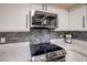 Close up of stainless steel appliances and gray backsplash at 4083 Nook Way # A, Las Vegas, NV 89103