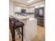 Well-appointed kitchen with a breakfast bar, modern appliances, sleek countertops, and white cabinets at 4083 Nook Way # A, Las Vegas, NV 89103