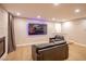 Modern living room with stylish gray furniture, a large flat-screen TV, recessed lighting, and hardwood floors at 4083 Nook Way # A, Las Vegas, NV 89103