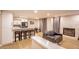 Open-concept space with modern kitchen, stone fireplace, hardwood floors, and sleek black leather seating at 4083 Nook Way # A, Las Vegas, NV 89103