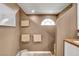 Stylish bathroom featuring a unique architectural design, walk-in shower, neutral tones, and natural light at 4542 Amber Canyon Ln, Las Vegas, NV 89129