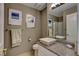 Bathroom featuring granite countertop, vessel sink, framed mirror and ceramic tile floors at 4542 Amber Canyon Ln, Las Vegas, NV 89129