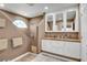 Bright bathroom featuring double sinks, modern vanity, walk-in shower, neutral tones, and lots of natural light at 4542 Amber Canyon Ln, Las Vegas, NV 89129