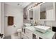 Modern bathroom featuring double sinks, mirrors, and a walk-in shower with light gray tile at 4542 Amber Canyon Ln, Las Vegas, NV 89129
