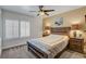 Serene bedroom with a wooden bed frame, neutral color scheme, and shuttered windows at 4542 Amber Canyon Ln, Las Vegas, NV 89129