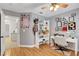 Bright bedroom featuring hardwood floors, a ceiling fan, and a desk at 4542 Amber Canyon Ln, Las Vegas, NV 89129