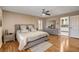 Bedroom featuring laminate floors, neutral walls, ceiling fan, and updated furnishings at 4542 Amber Canyon Ln, Las Vegas, NV 89129