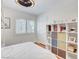 Bedroom with a bunk bed, hardwood floors, a ceiling fan, white walls, and shelves at 4542 Amber Canyon Ln, Las Vegas, NV 89129