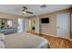 Bedroom with laminate floors, neutral walls, ceiling fan, and access to the Primary bathroom at 4542 Amber Canyon Ln, Las Vegas, NV 89129
