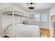 Bedroom with a bunk bed, hardwood floors, a ceiling fan, white walls, and window blinds at 4542 Amber Canyon Ln, Las Vegas, NV 89129