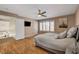 Lovely bedroom features laminate floors, ceiling fan, neutral paint and window shutters at 4542 Amber Canyon Ln, Las Vegas, NV 89129