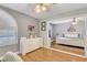 Bright bedroom with hardwood floors, a ceiling fan, an arched window, and view to the next room at 4542 Amber Canyon Ln, Las Vegas, NV 89129