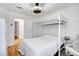 Bright bedroom featuring a bunk bed, wood floors, and ceiling fan with a light at 4542 Amber Canyon Ln, Las Vegas, NV 89129