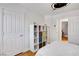 Bedroom with a bunk bed, hardwood floors, a ceiling fan, white walls, and a closet at 4542 Amber Canyon Ln, Las Vegas, NV 89129