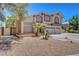 Attractive two-story house with a three-car garage, tile roof, and desert landscaping at 4542 Amber Canyon Ln, Las Vegas, NV 89129