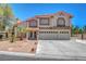 Charming two-story home featuring a three-car garage, tile roof, and well-maintained landscaping at 4542 Amber Canyon Ln, Las Vegas, NV 89129
