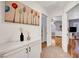 Hallway with art on the wall, white storage, and a bedroom with bamboo flooring in the distance at 4542 Amber Canyon Ln, Las Vegas, NV 89129