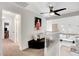 Hallway leading to kitchen with white banister, ceiling fan, carpet flooring, and leather seating at 4542 Amber Canyon Ln, Las Vegas, NV 89129