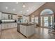 Spacious kitchen with island, stainless steel appliances, white cabinetry, and access to outdoor patio at 4542 Amber Canyon Ln, Las Vegas, NV 89129